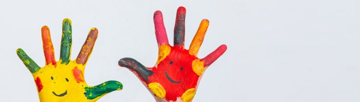 The hands of the child who smeared on the gray background.